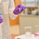 Above, a scientist preparing to extract DNA from a sample.
